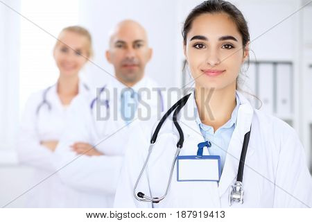 Happy doctor woman with medical staff at the hospital.
