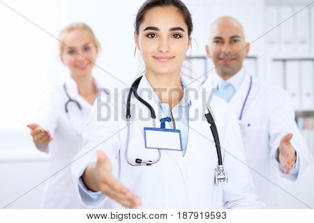Happy doctor woman with medical staff at the hospital. Helping hand