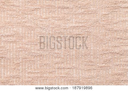 Light beige fluffy background of soft fleecy cloth. Texture of cream plush furry textile closeup.