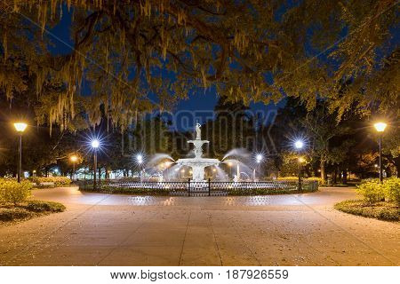 Water fountain at night Forsyth fountain in historic Savannah Georgia. Dramatic view with lots of star bursts and water spray.
