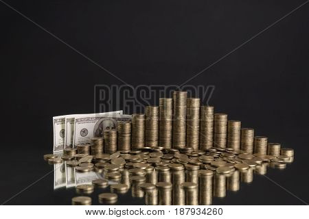 photo of piles of coins in the shape of a pyramid on the grey background