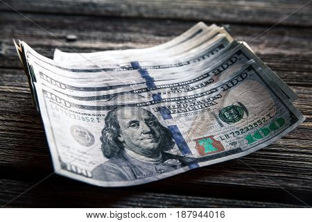 money on a wooden background. lot 100 dollars, business composition