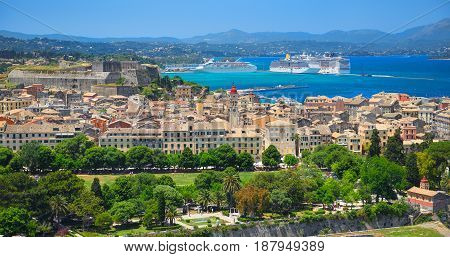 Panoramic view on classical Greek houses buildings architecture of Greece Corfu island capital Kerkyra, white cruise liner ship. Greece holidays vacation touristic tours. Sightseeing view point