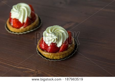 Two Delicious Strawberry Tarts With Chantilly Cream - Tartellete - On An Ipe Natural Wood Table