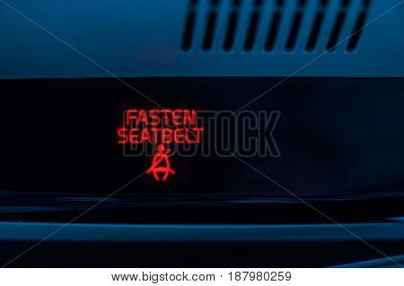 Close up red indicator in car saying fasten seatbelts