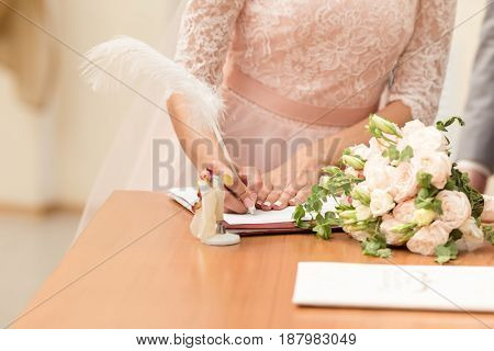Bride And Bridegroom Signing The Marriage Contract After The Wedding Ceremony