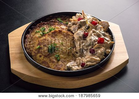 Traditional Belarusian Draniki With A Garnish Of Chicken Pieces