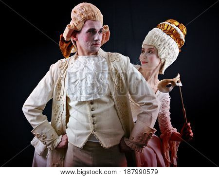 Man and woman in ancient costumes and white wigs
