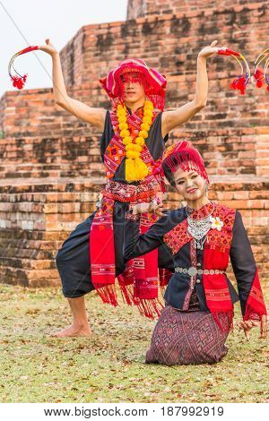 KALASIN THAILAND - FEBRUARY 20 2016: Girl and boy dancers with local dress doing Thai Northeastern traditional dance at Yaku Pagoda to celebrate Buddism event in Kalasin