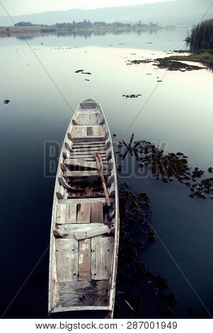 The Wooden Boat Was Resting In The River Calmly.
