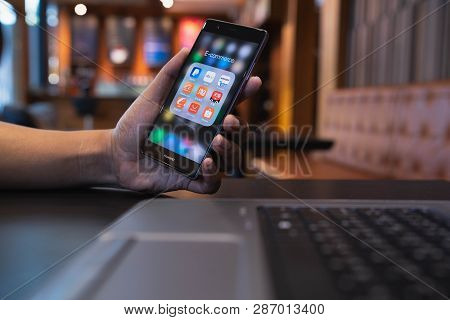 Chiang Mai, Thailand - May 05,2018: Man Holding Huawei With Icons Of E-commerce And Online Shopping 