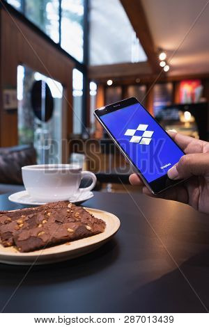 Chiang Mai, Thailand - May 09,2018: Man Holding Huawei With Dropbox On Screen. Dropbox Is A Service 