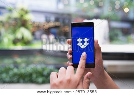 Chiang Mai, Thailand - May 05,2018: Man Holding Huawei With Dropbox On Screen. Dropbox Is A Service 