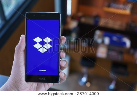 Chiang Mai, Thailand - April 21,2018: Man Holding Huawei With Dropbox On Screen. Dropbox Is A Servic