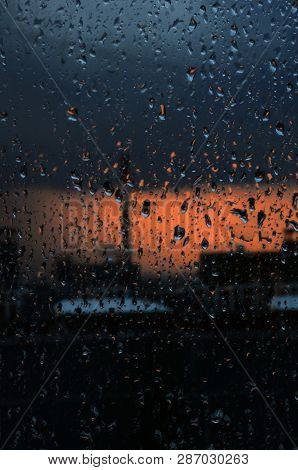 Rain Drops On The Window Glass, And The Window Of The City And The Storm
