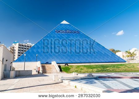 Eilat, Israel - February 9, 2019: The Blue Pyramid Of Imax Cinema In The Gan Binyamin Central Park.