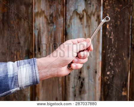 Hand Holding Wrench On A Wooden Background, Husky Metric Drive Ratcheting