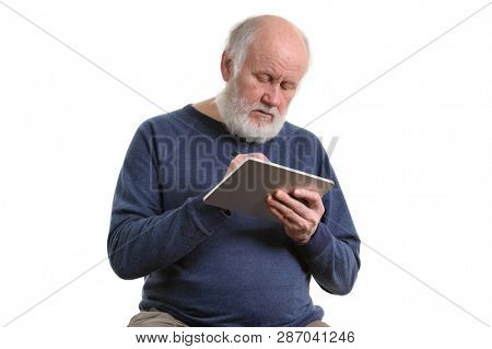Funny bald and bearded old man using tablet computer, isolated on white