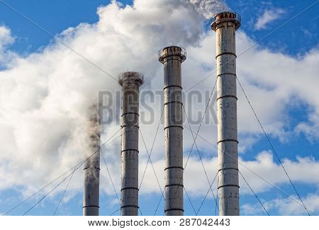 Air Pollution From Industrial Plants. Smoking Industrial Pipes. Steel Pipe.