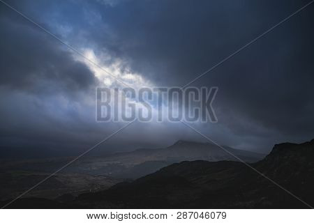 Dark And Dramatic Winter Landscape Image Of Moel Saibod From Crimpiau In Snowdonia With Stunning Sha