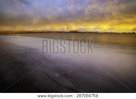 Colorful Clouds Over A Frozen Winter Lake