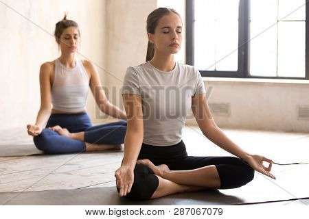 Yogi Young Woman And Group Of People In Half Lotus