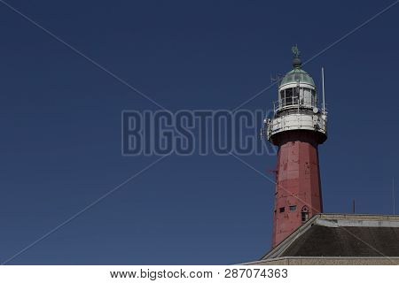 Lighthouse In Schevenigen, The Hague Beatch Against A Pur And Blue Sky At Summer Time