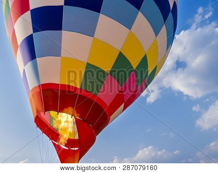Close Up Of Propane Gas Fire Burner In Hot Air Balloon For Take Off Under Blue Sky And White Cloud A