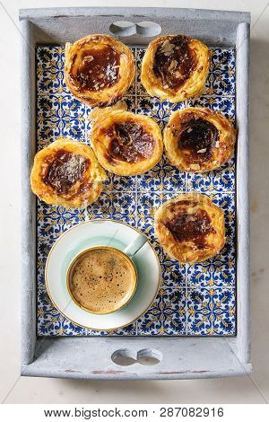 Traditional Portuguese Egg Tart Dessert Pasteis Pastel De Nata In Classic Tile Tray With Cup Of Blac