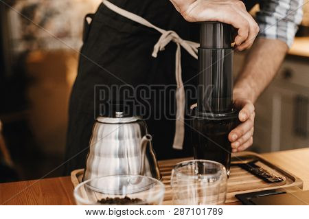 Professional Barista Preparing Coffee By Aeropress Alternative Method, Brewing Process. Hands On Aer