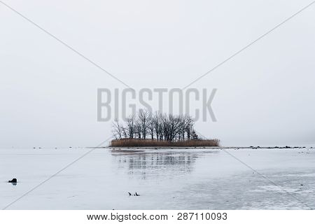 Island On Ice Covered Lake