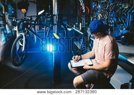 Young Handsome Stylish Man In A Cap Snapback And With A Tattoo Small Business Owner Selling A Bicycl