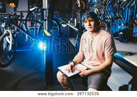Young Handsome Stylish Man In A Cap Snapback And With A Tattoo Small Business Owner Selling A Bicycl