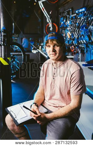 Young Handsome Stylish Man In A Cap Snapback And With A Tattoo Small Business Owner Selling A Bicycl