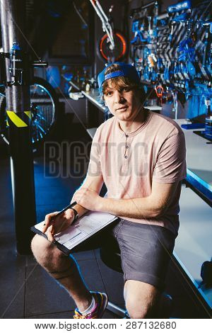 Young Handsome Stylish Man In A Cap Snapback And With A Tattoo Small Business Owner Selling A Bicycl