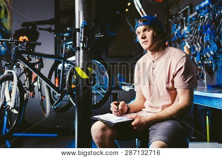 Young Handsome Stylish Man In A Cap Snapback And With A Tattoo Small Business Owner Selling A Bicycl