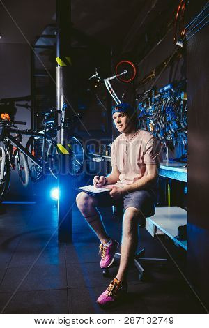 Young Handsome Stylish Man In A Cap Snapback And With A Tattoo Small Business Owner Selling A Bicycl