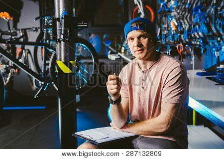 Young Handsome Stylish Man In A Cap Snapback And With A Tattoo Small Business Owner Selling A Bicycl