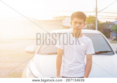 Photo Of A Young Thai Boy Is Standing Front Of The Dirty Wall In The White Shirt With Smilingly Happ