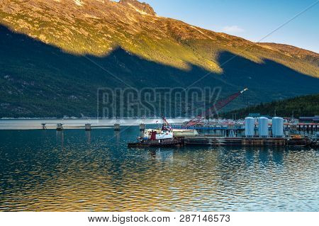 September 15, 2018 - Skagway, Ak: Broadway Dock With Tugboat And Crane At Sunrise.