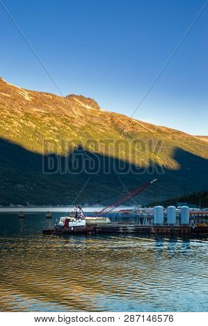 September 15, 2018 - Skagway, Ak: Broadway Dock With Tugboat And Crane At Sunrise.