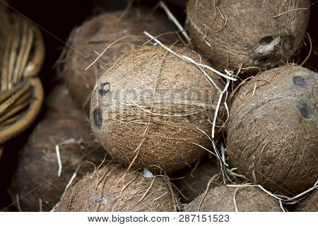 A Group Of Nappy Brown Kakos Nuts In A Basket On The Market. Background, Texture, Cropped Shot, Hori