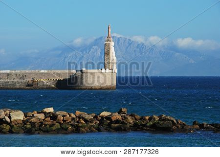 View Of The Harbour Wall And Entrance With Views To The Moroccan Coastline And Rif Mountains, Tarifa