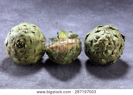 Artichokes On Rustic Background. Fresh Organic Artichoke Flower Set
