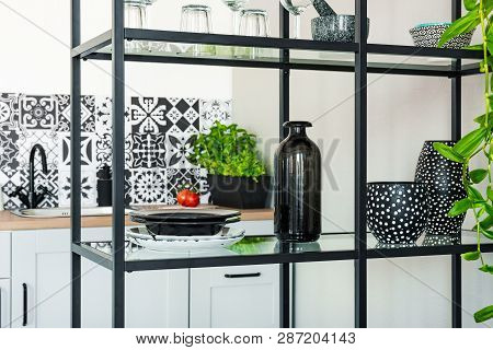 Plates, Vases And Pots On Metal Shelf In White Scandinavian Kitchen