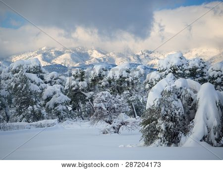 View Of Snow Covered Mountain Dirfys And Sky With Clouds On A Sunny Day On The Island Of Evia, Greec
