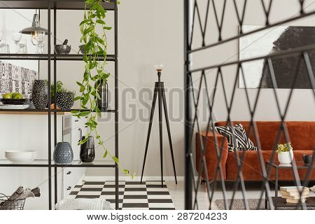 Fancy Metal Lamp In The Middle Of Fashionable Kitchen With Industrial Furniture And Brown Velvet Cou