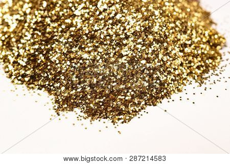 A Bunch Of Golden Nail Gritter For Manicure. Golden Glitter Shining On Daylight. Stock Photo Isolate