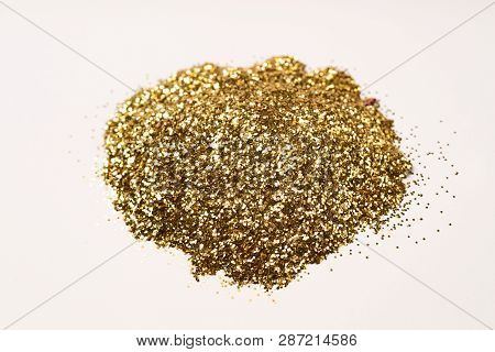 A Bunch Of Golden Nail Gritter For Manicure. Golden Glitter Shining On Daylight. Stock Photo Isolate