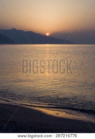 Waves And Beautiful Sunset On The Greek Island Evia (euboea) In The Aegean Sea
